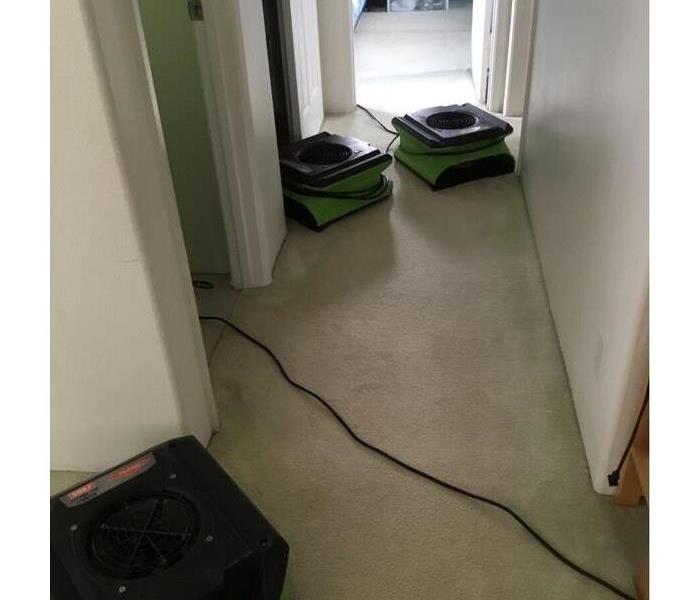 hallway with dry carpet and SERVPRO fans placed 