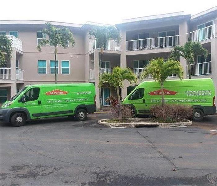Two green SERVPRO vans parked outside Hawaii Kai Retirement Home