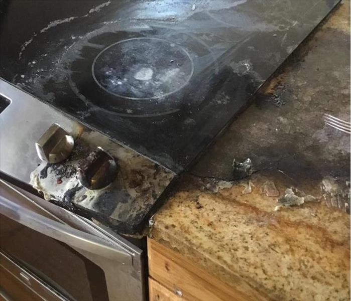 Kitchen counter tops charred and shove handles melted