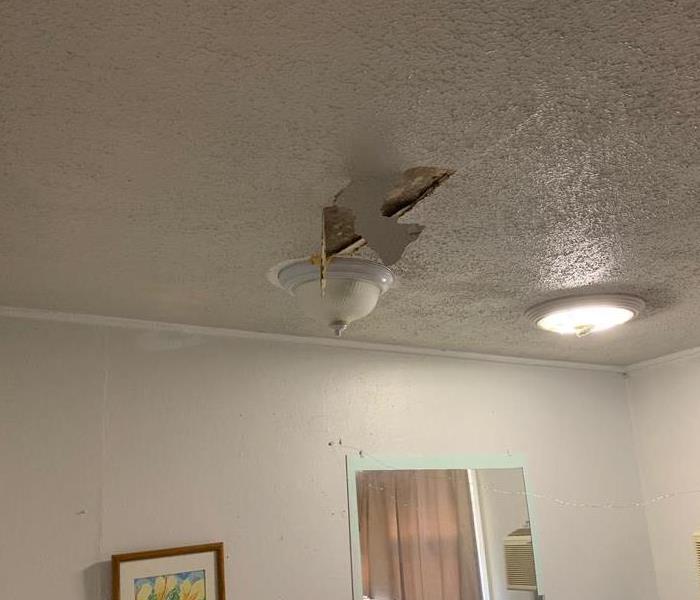 part of ceiling hanging near light fixture